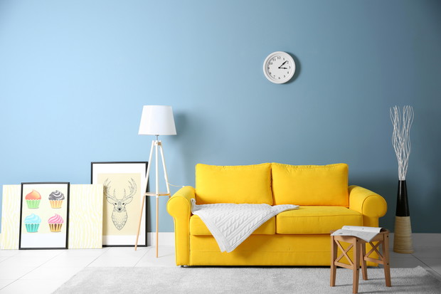 Room interior with yellow sofa on blue wall background