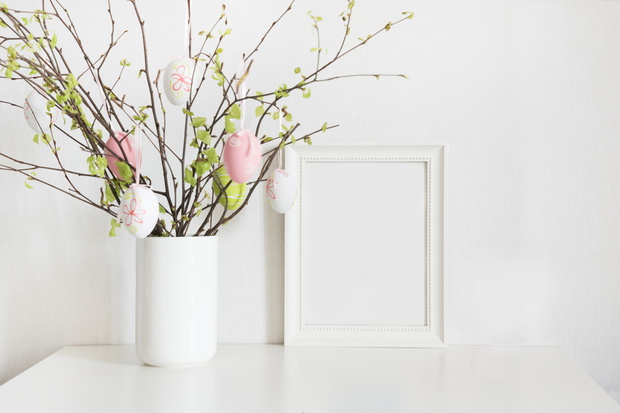 Easter. Vase with birch tree branches with Easter eggs and frame.