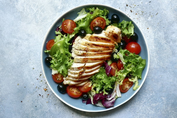 Grilled chicken breast with vegetabe salad. Top view with copy space.