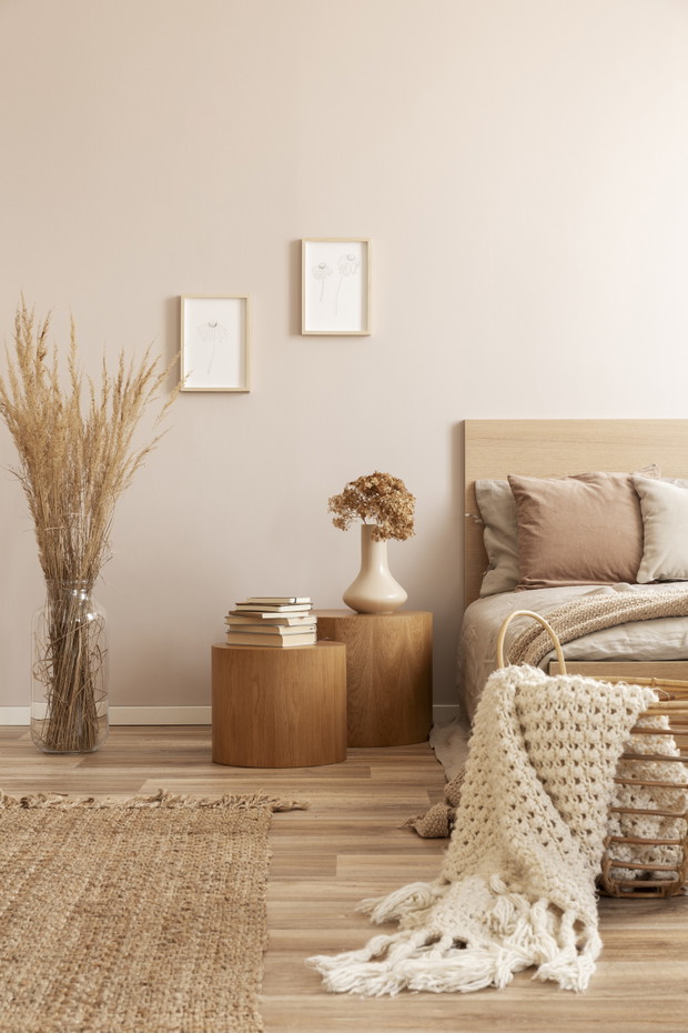 Beige kid's room with wooden nightstand with flowers and single