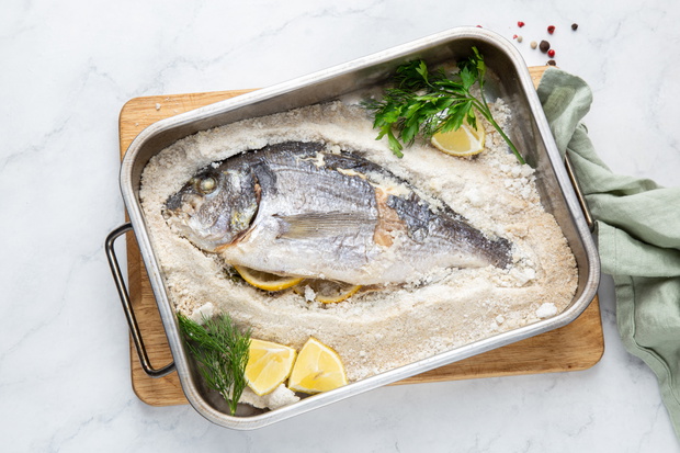 delicious salt-baked dorada fish with lemon and herbs