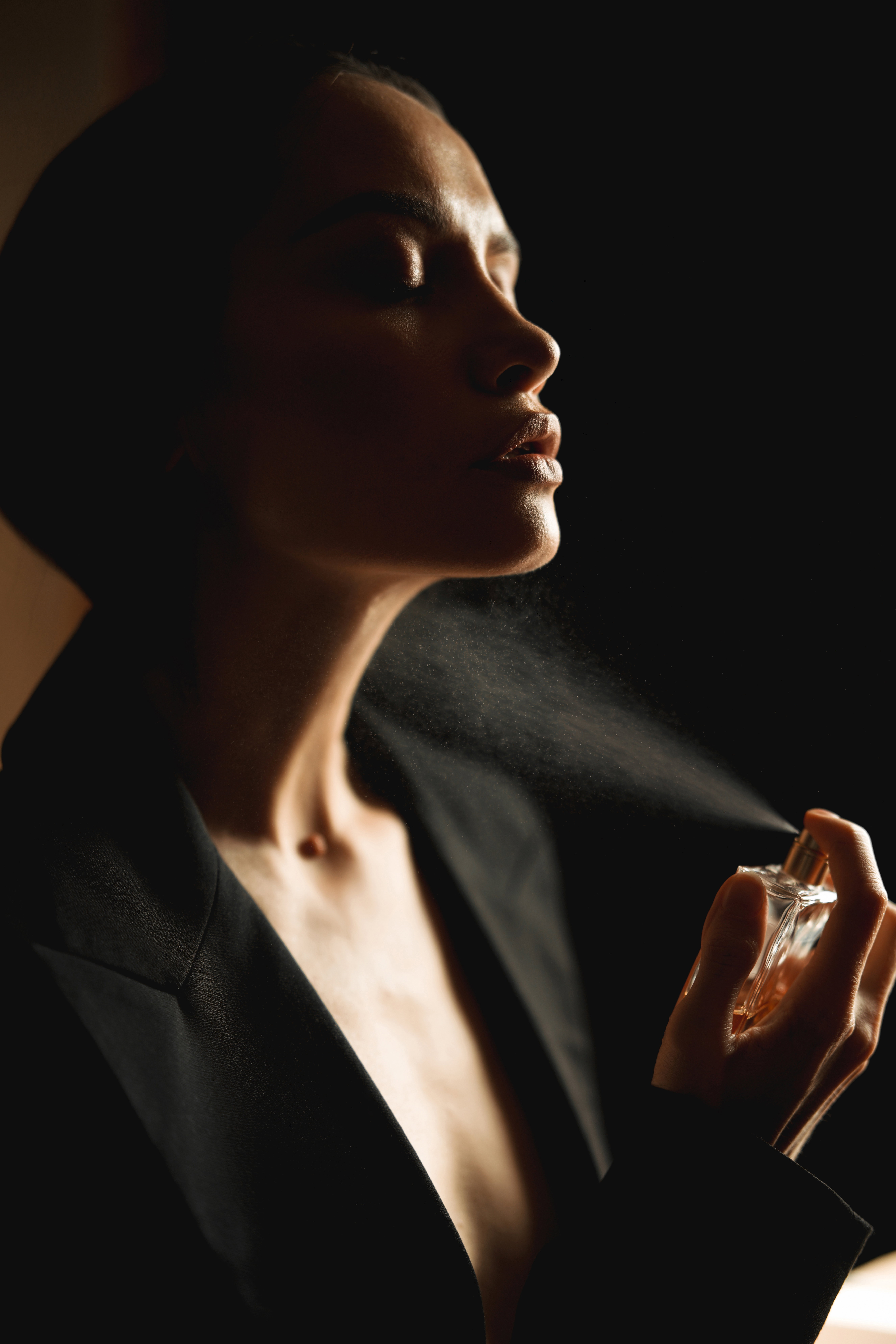 Womman spraying perfume