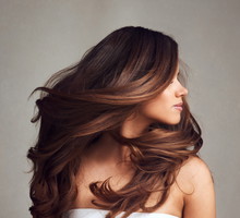 Making hairstory everyday with gorgeous hair. Studio shot of a young beautiful woman with long gorgeous hair posing against a grey background.