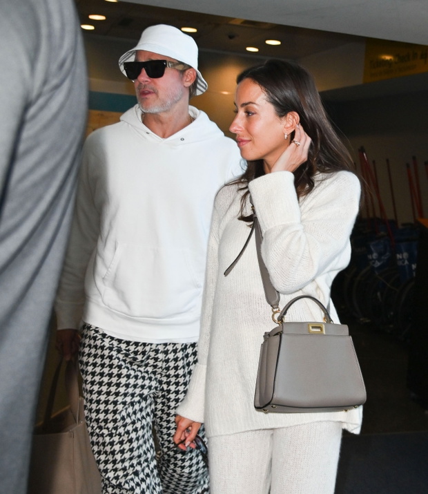 Brad Pitt and Ines de Ramon try to keep a low profile while leaving NYC hotel