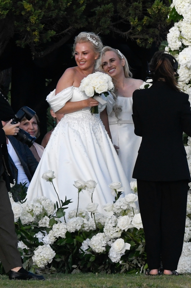 *PREMIUM-EXCLUSIVE* *MUST CALL FOR PRICING * Australian actress Rebel Wilson and her fashion designer fiancée Ramona Agruma look stunning in white wedding dresses as the couple are married in a beautiful ceremony at the Hotel Cala di Volpe in Sardinia