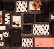 Elegant DIY advent calendar used to count the days in anticipation of Christmas. Countdown adult gifts wrapped in white and black papers and one special pink for Christmas Eve on a dark background.