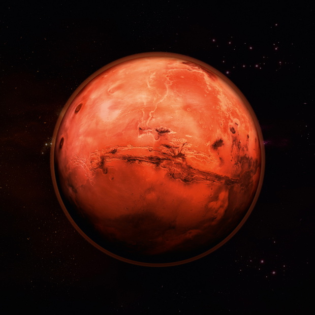 Planet Mars in space, red rock planet with red atmosphere with stars in the background. Elements of this image supplied by NASA