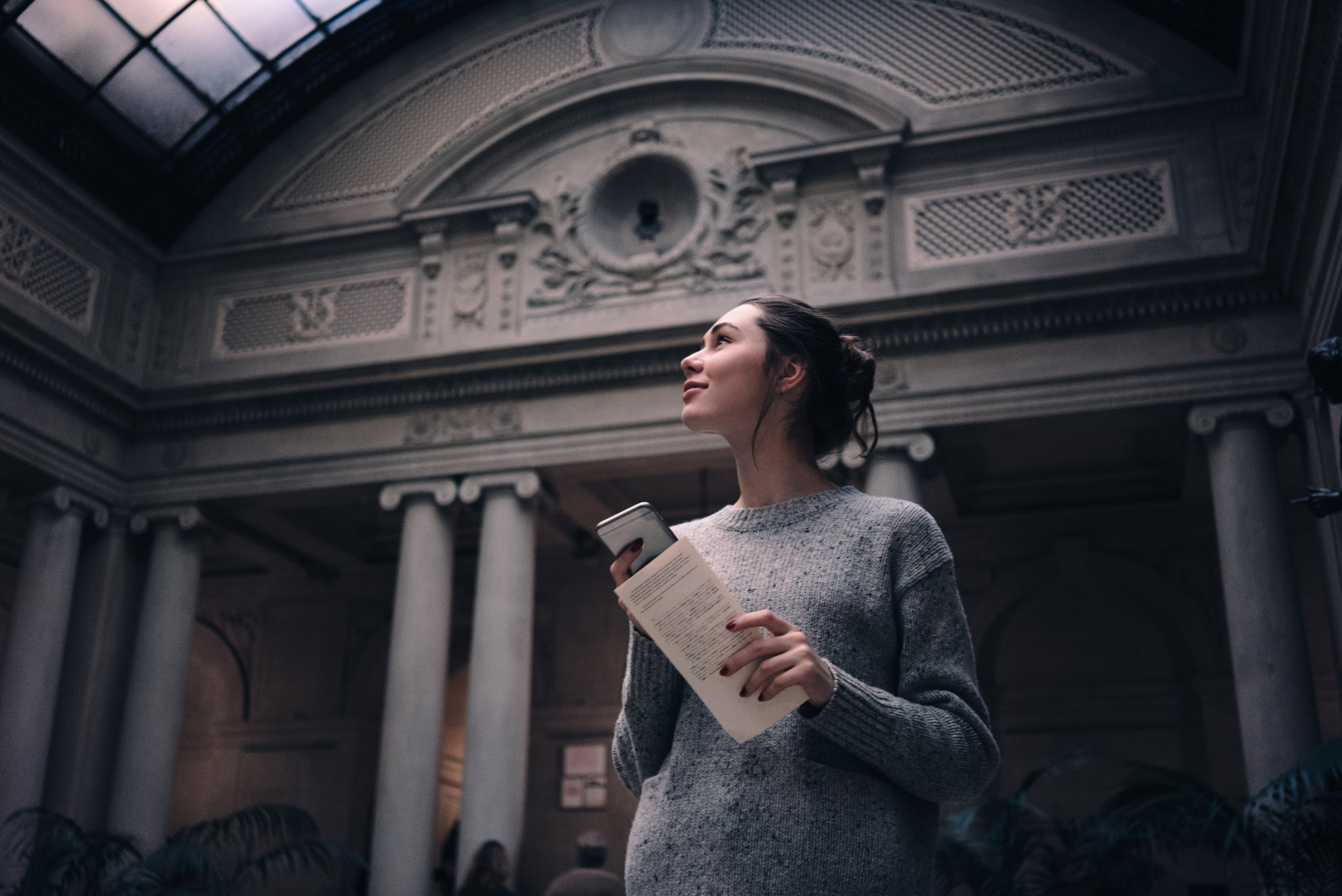 Portrait of a young attractive woman visiting museum or gallery