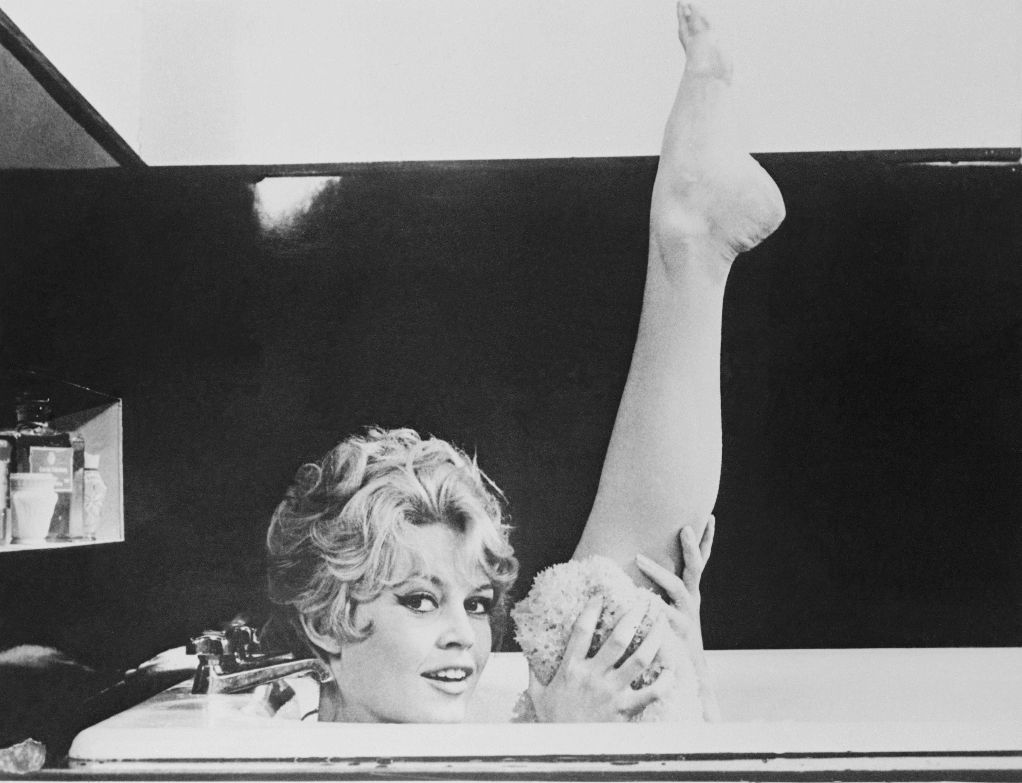 Actress Brigitte Bardot Holding up Leg in Bathtub