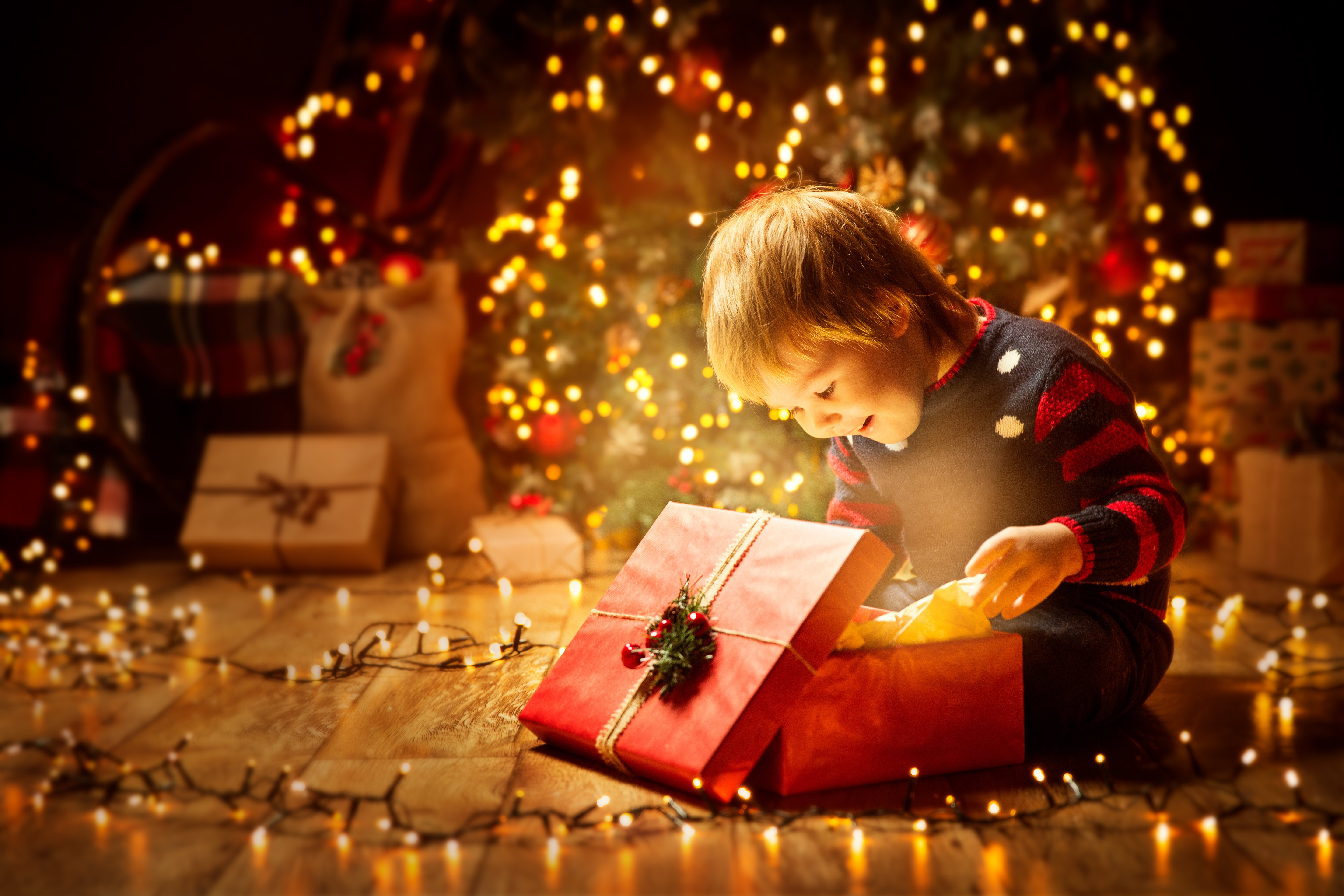 Christmas Child Open Present Gift, Happy Baby Boy looking to Mag