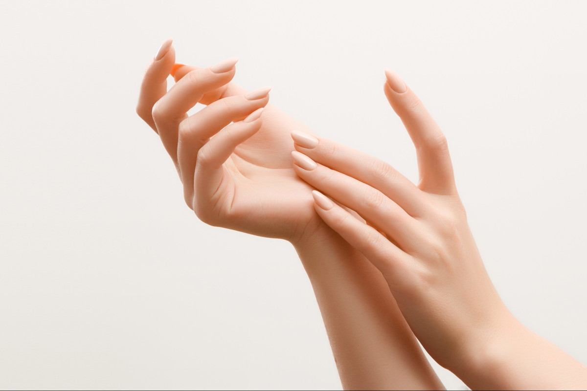 Beautiful Woman Hands. Female Hands Applying Cream, Lotion. Spa and Manicure concept. Female hands with french manicure. Soft skin, skincare concept. Hand Skin Care.