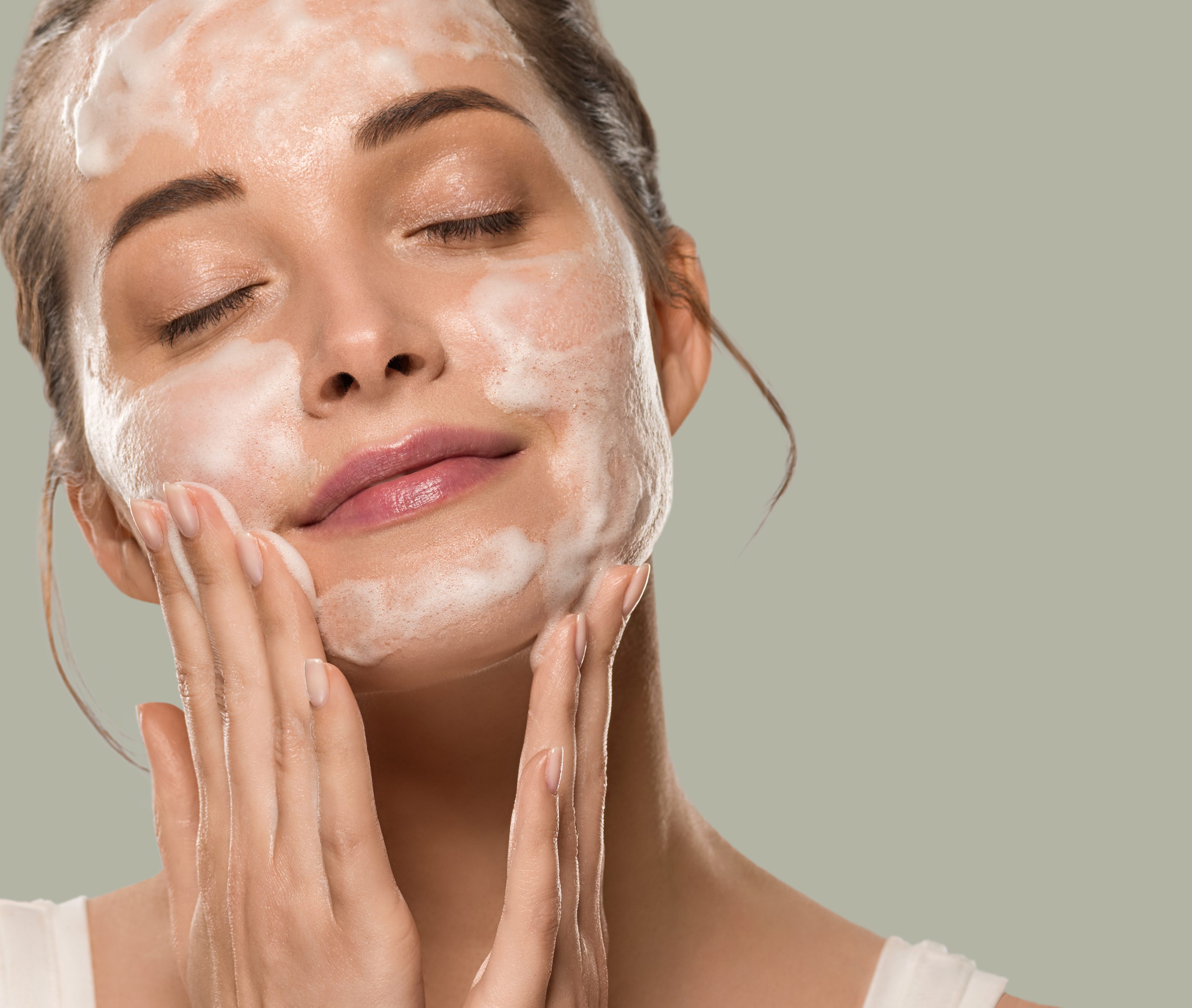 Soap face woman clean skin beauty. Color background. Green
