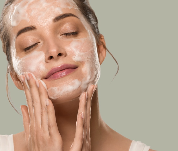 Soap face woman clean skin beauty. Color background. Green