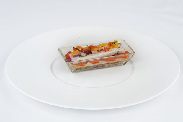 Dressed herring with tomatoes, salad and orange slices. Beautifully decorated snack from herring.