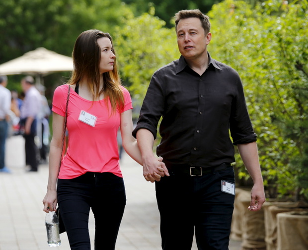 Tesla founder Musk walks with his wife during the first day of the annual Allen and Co. media conference in Sun Valley