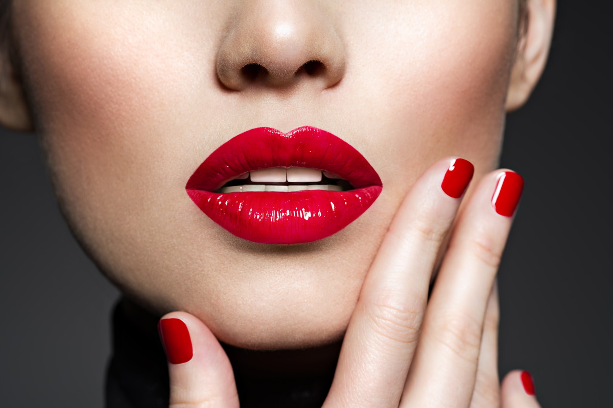 Closeup sexy female lips with red lipstick.