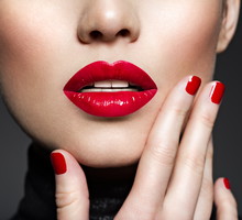 Closeup sexy female lips with red lipstick.