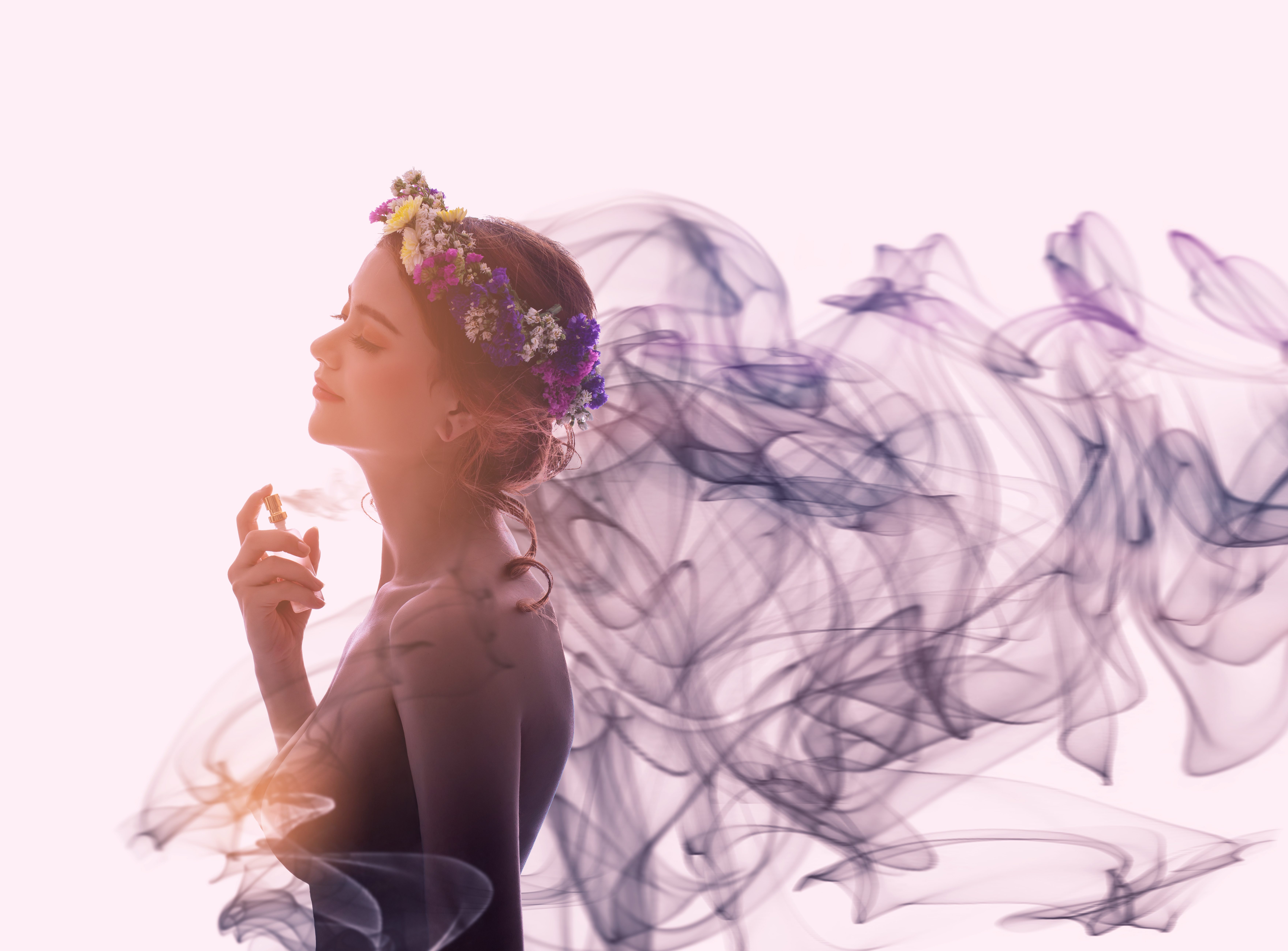 Charming woman spray perfume on her body. She has sexual attraction.