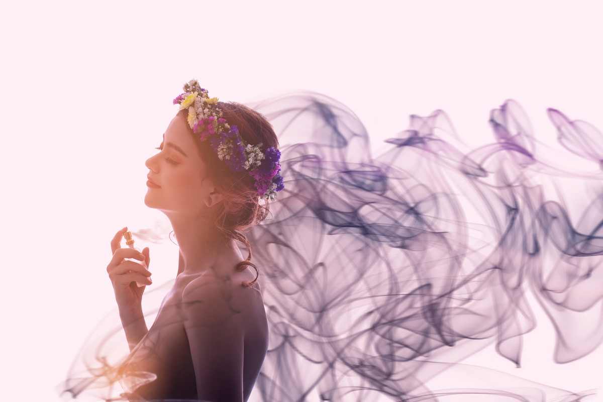Charming woman spray perfume on her body. She has sexual attraction.