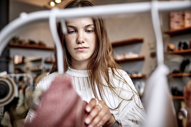 Portrait of young woman in a fashion store