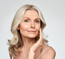 Beautiful gorgeous mid aged mature woman looking at camera isolated on white.