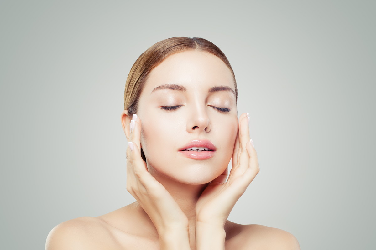 Pretty woman with closed eyes and young healthy skin. Facial tr