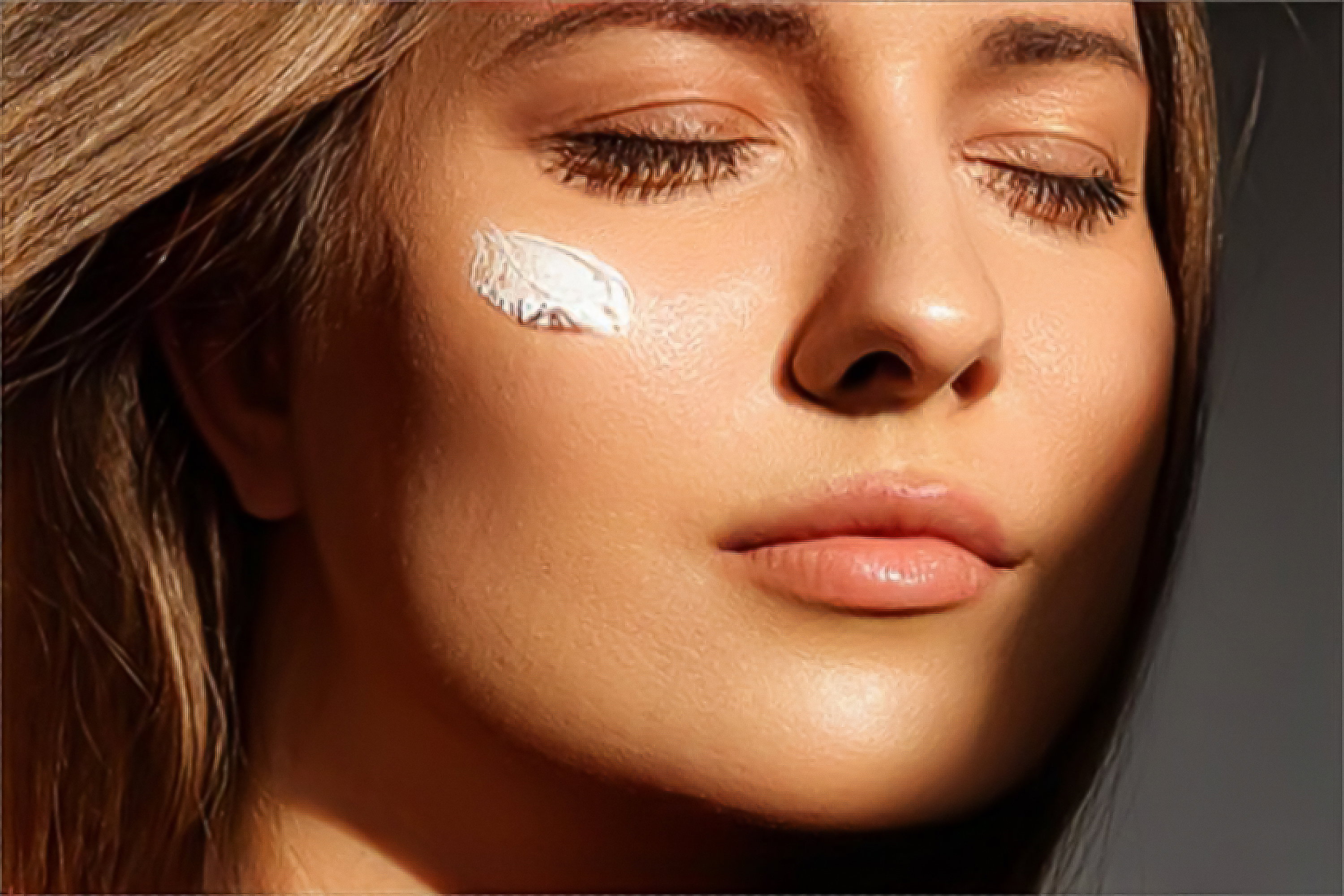 Beauty, suntan spf and skincare cosmetics model face portrait, woman with moisturising cream, sunscreen product or sun tan lotion on her cheek, luxury facial and skin care