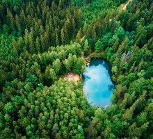 Aerial view of blue colored forest lake in Poland