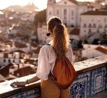 Female tourist looking at old town from balcony