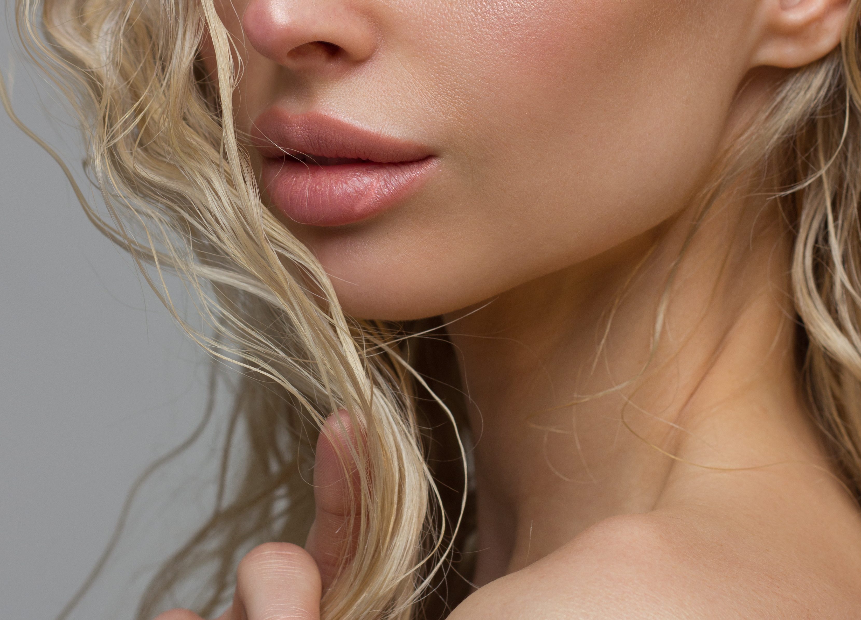 Close-up of woman's Lips with Fashion pink Make-up and Manicure on Nails. Beautiful female full lips with perfect Makeup. Part of female face. Macro shot of beautiful make up on full lips