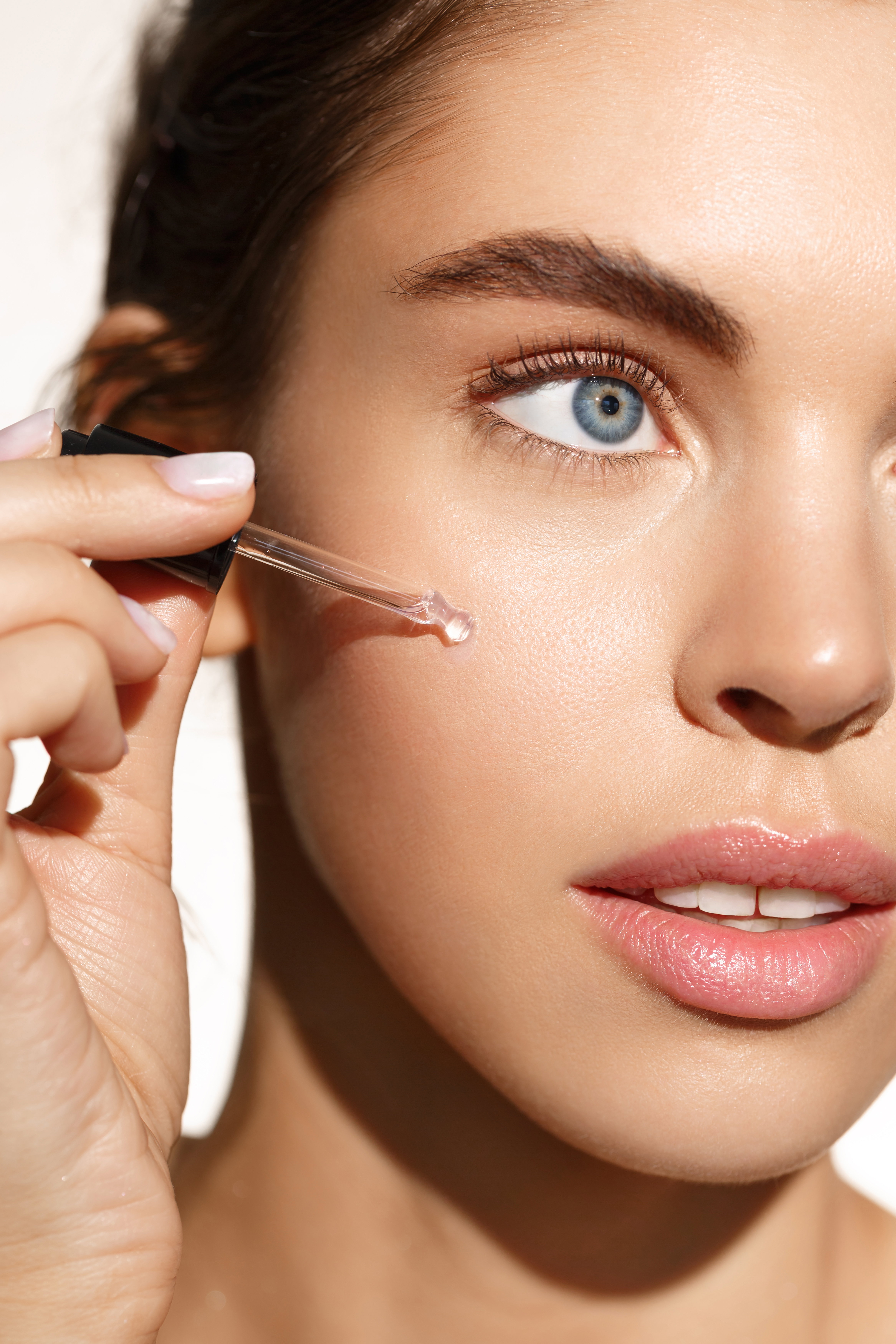 Beauty and skincare concept. Female model using natural moisturizer with active natural ingredients, collagen and hyaluronic acid for better skin tone and face nourishment