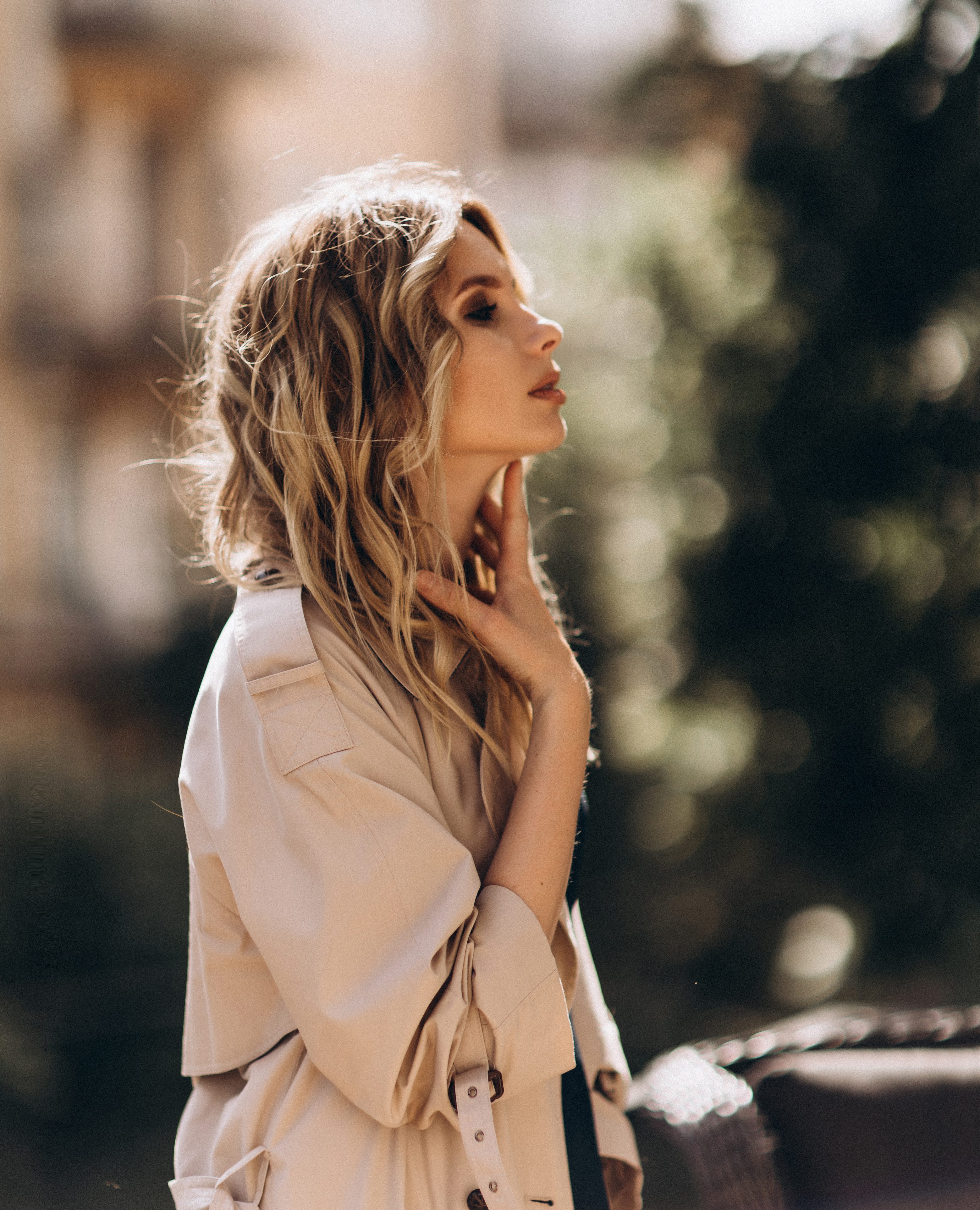 Fashionable portrait of a stylish blonde woman in elegant totall beige look and a combination dress. Spring - autumn fashion concept. Soft selective focus.