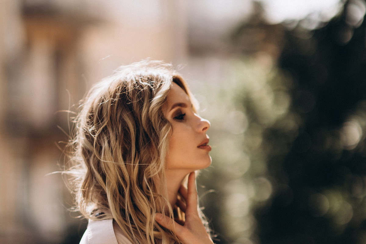 Fashionable portrait of a stylish blonde woman in elegant totall beige look and a combination dress. Spring - autumn fashion concept. Soft selective focus.