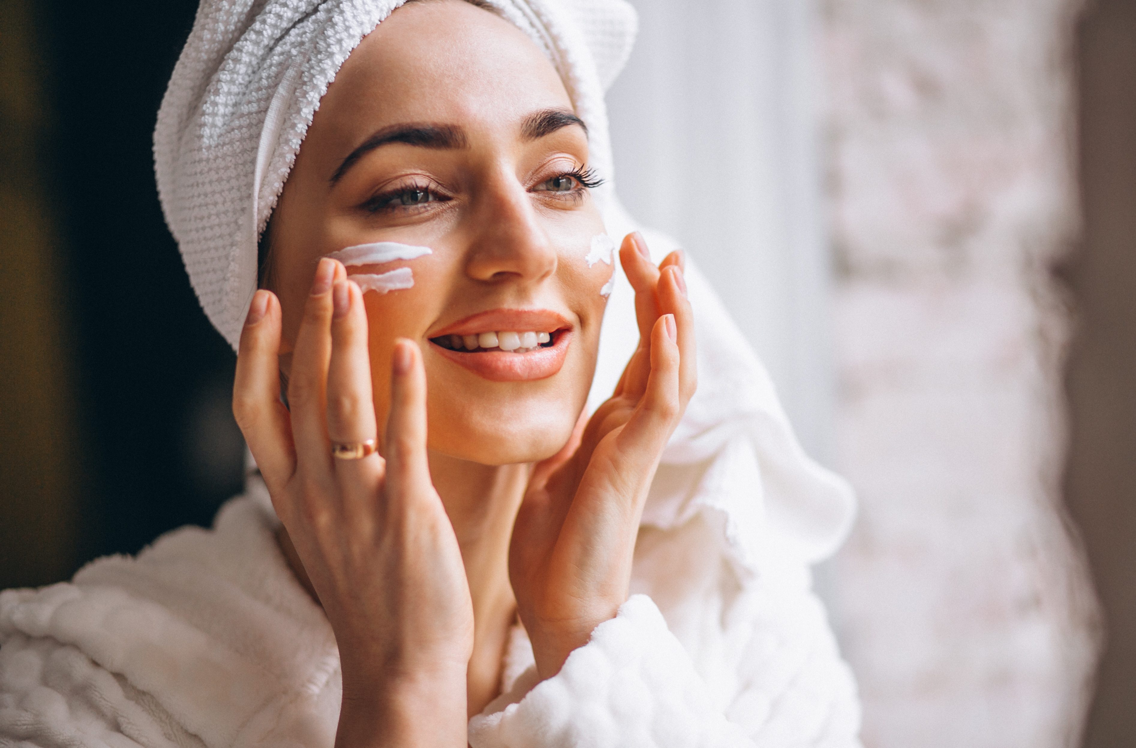 Woman applying face cream