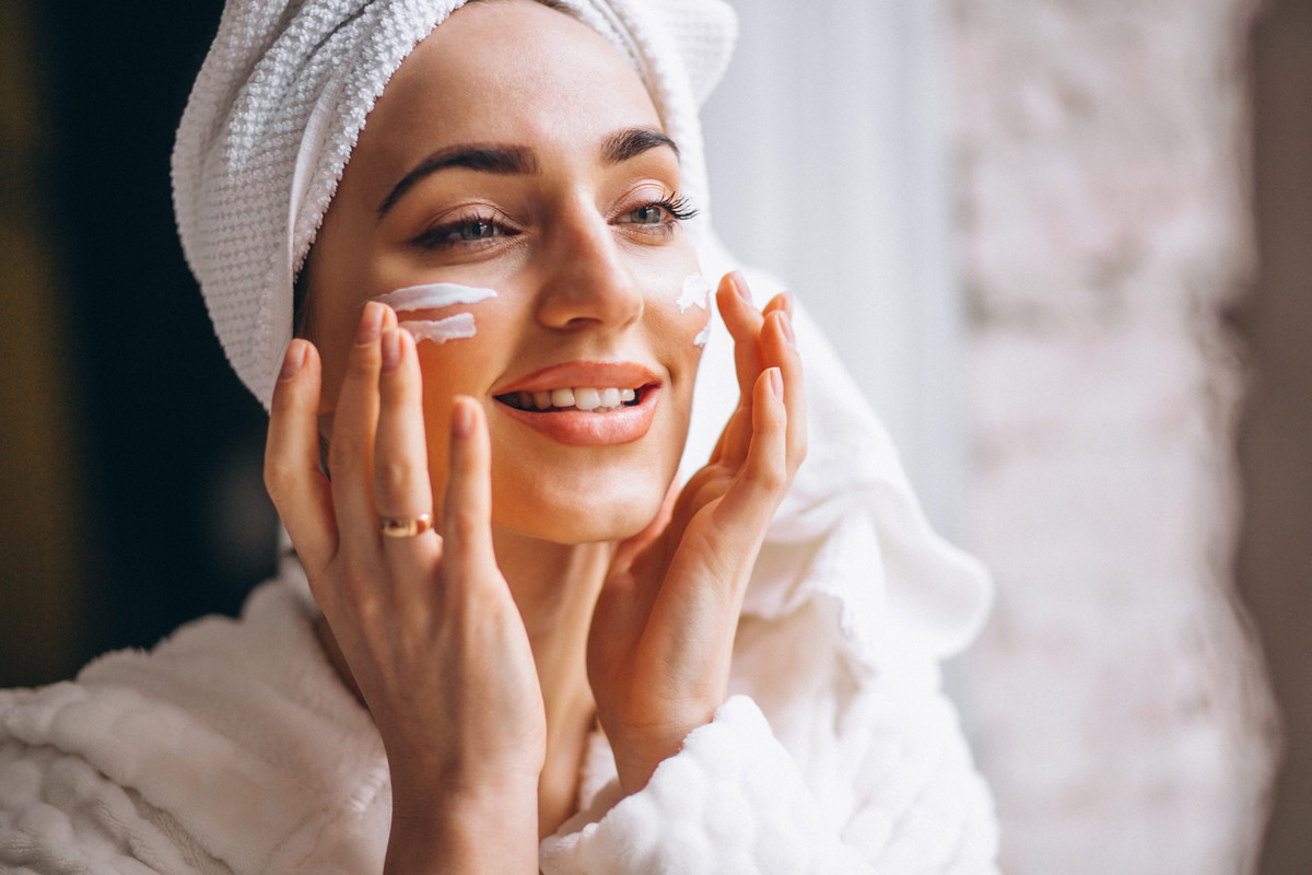 Woman applying face cream