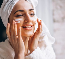 Woman applying face cream
