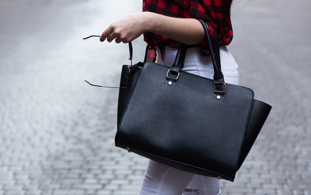 Woman holding black leather bag