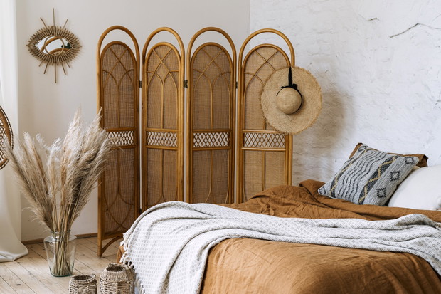 Comfort bedroom in boho style interior with lovely furnishing