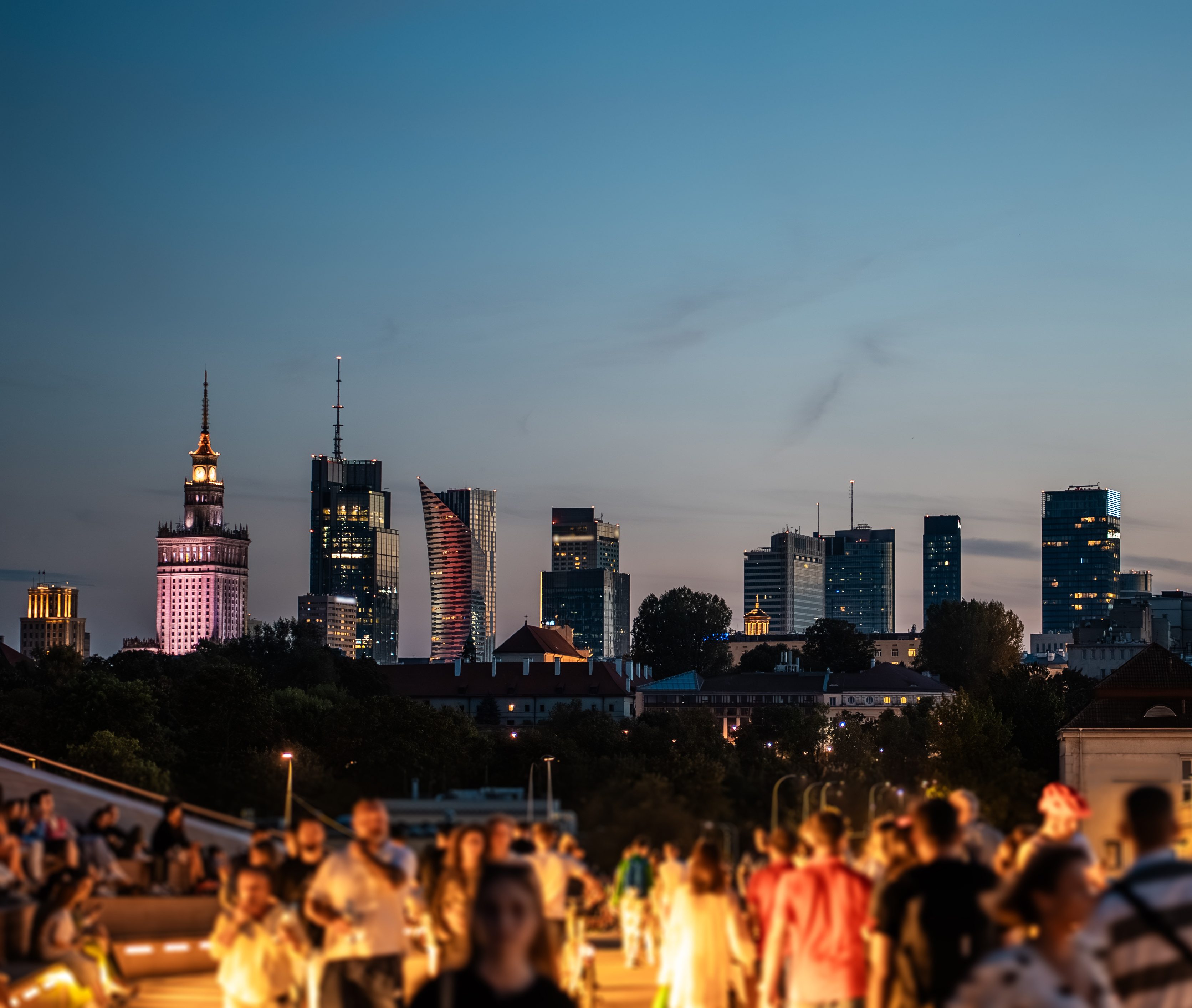 sunset over skyline of Warsaw city with skyscrapers and downtown district, crowd of people walking, tourist travel destination, rush hour in capital of Poland 4k, vertical video footage
