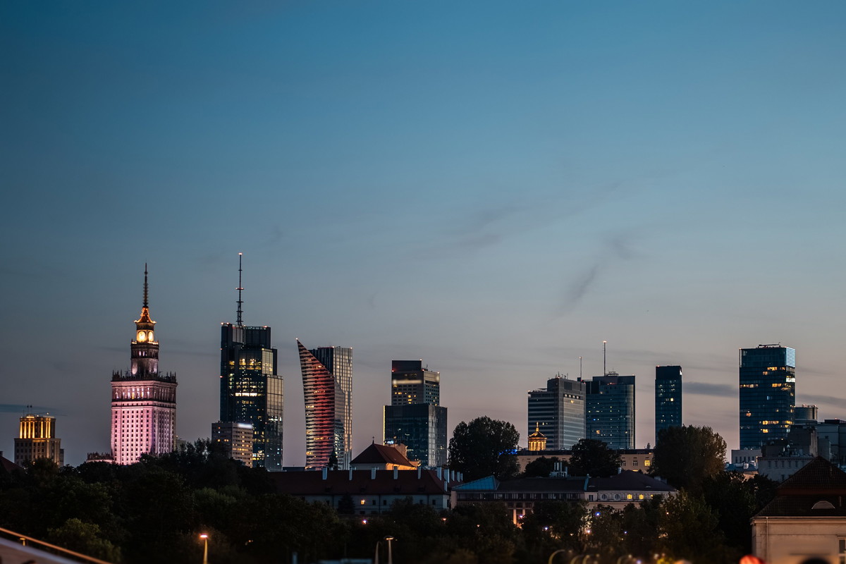 sunset over skyline of Warsaw city with skyscrapers and downtown district, crowd of people walking, tourist travel destination, rush hour in capital of Poland 4k, vertical video footage