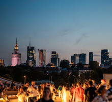 sunset over skyline of Warsaw city with skyscrapers and downtown district, crowd of people walking, tourist travel destination, rush hour in capital of Poland 4k, vertical video footage