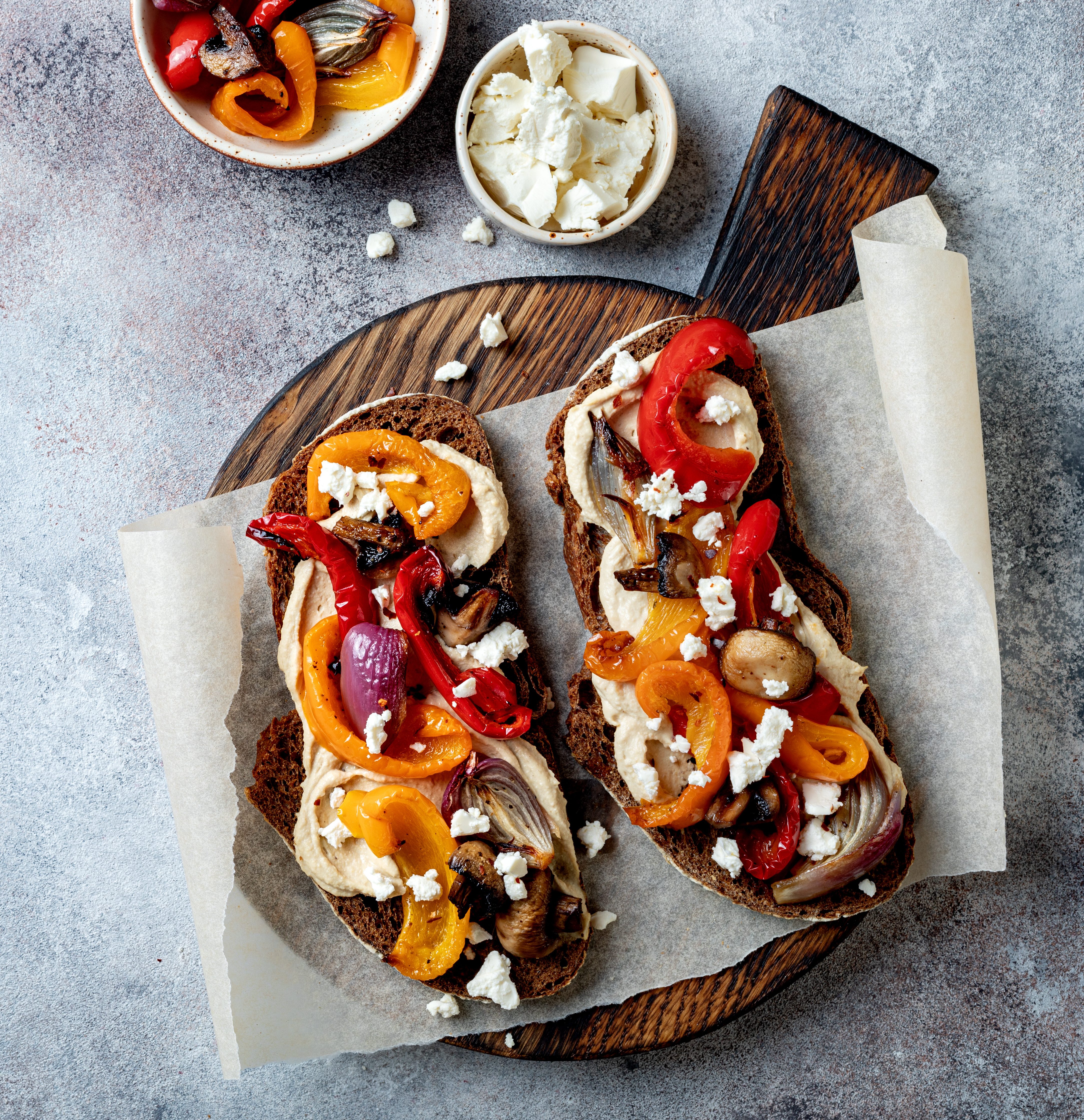 Roasted vegetables toast with hummus and feta cheese