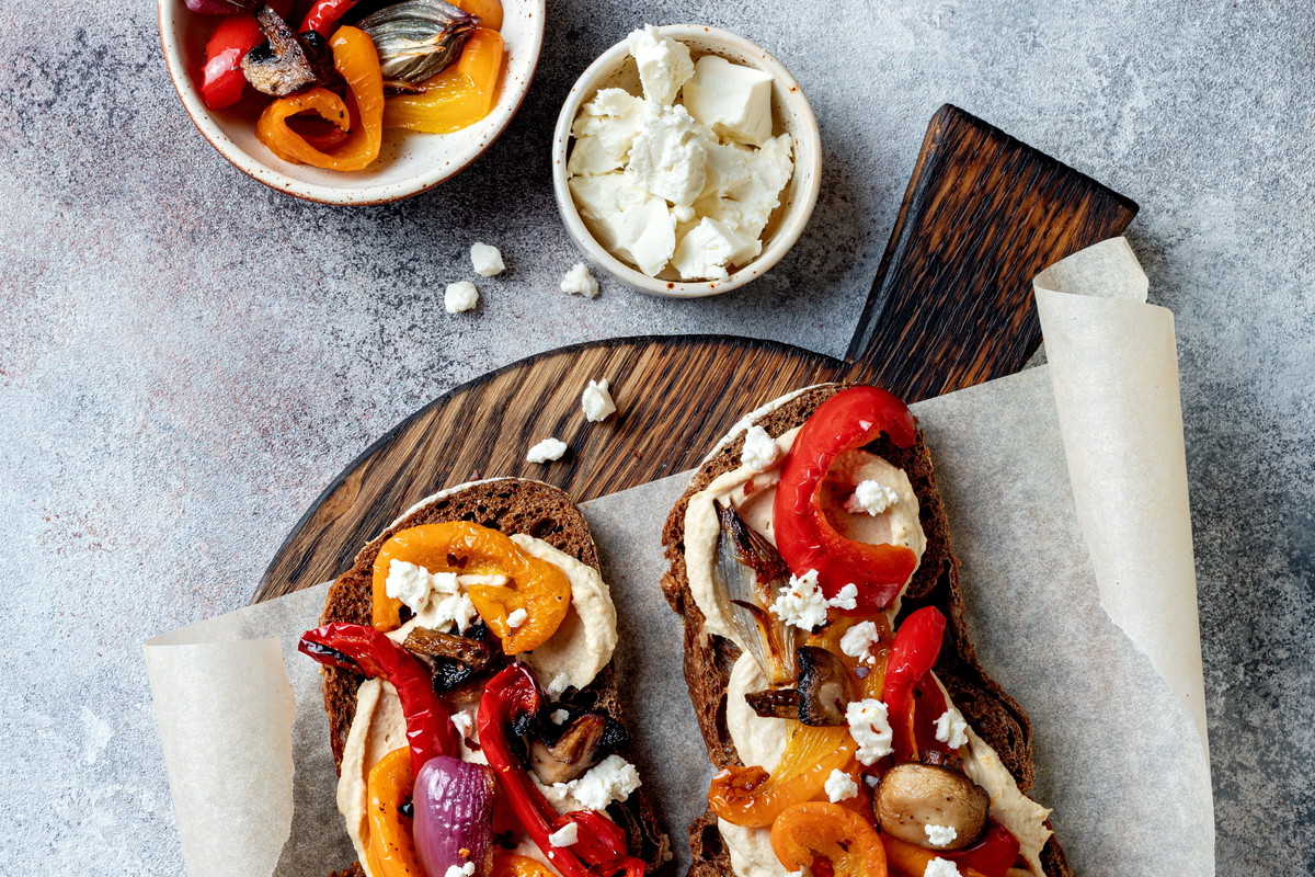 Roasted vegetables toast with hummus and feta cheese