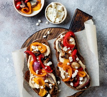 Roasted vegetables toast with hummus and feta cheese
