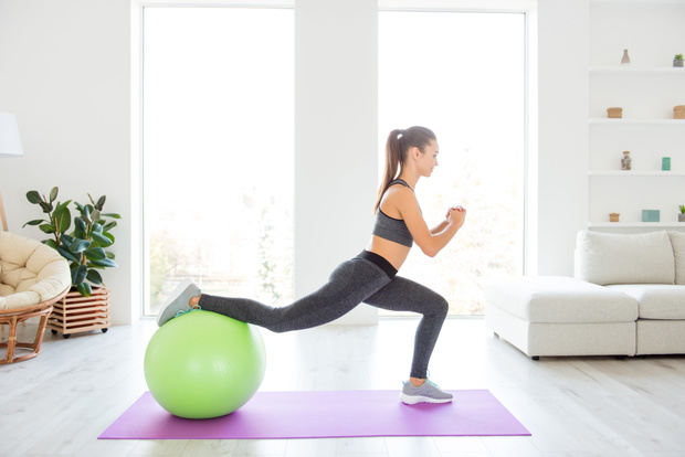 Trainer vitality wellness wellbeing lifestyle daydream instructor concept. Profile full length size photo portrait of beautiful strong sporty sportive with ponytail hair doing squat using fitness ball