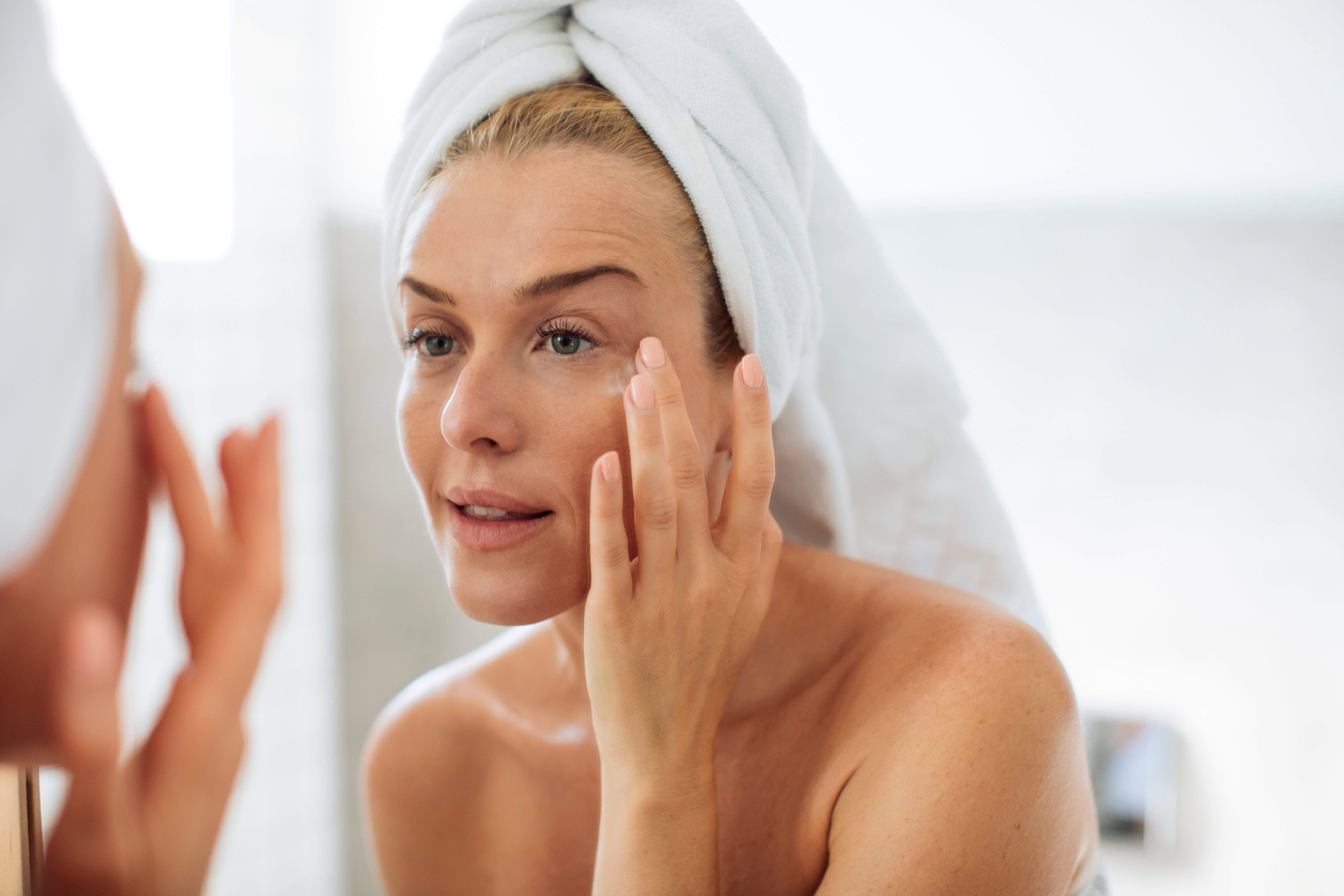 Woman Applying Moisturising Creme on Her Face