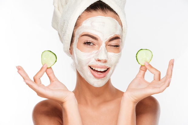 Young woman with clay facial mask
