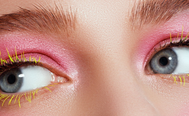 Creative beauty Makeup. Natural long green eyelashes closeup. Beauty model woman face makeup with fantasy bright eyelash. Model face
