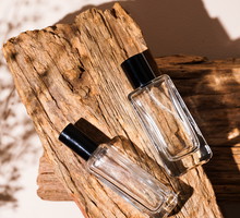 bottle of perfume on wooden background