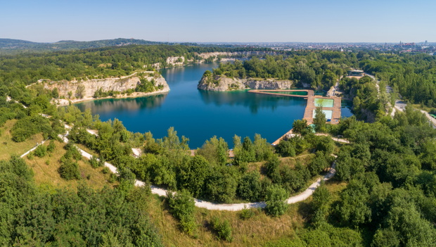Kraków, Polska. Zakrzówek lake with steep cliffs in place of former flooded limestone quarry. Recreational place with swimming pools, restaurants and other facilities under construction. Aerial view